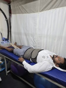 Physiotherapist assessing a patient's back and posture